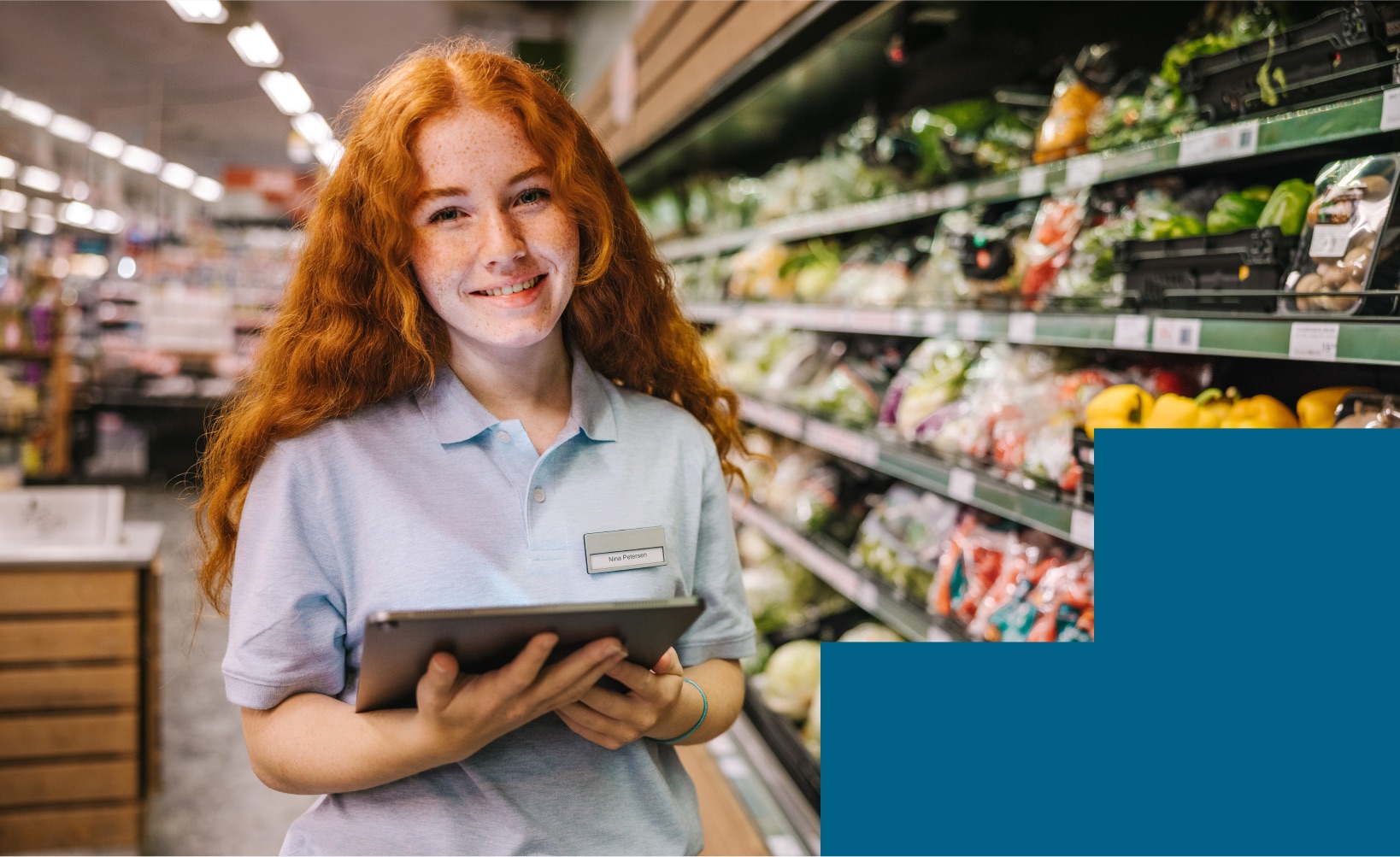 Student working at a local grocery store, showcasing real-world experience opportunities